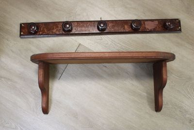 a wooden shelf with a coat rack on top of it