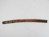 an old wooden stick with a metal handle on a white surface