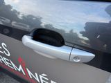 a close up of a car door handle with a sticker on it