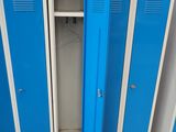 several blue lockers are lined up in a row in a warehouse