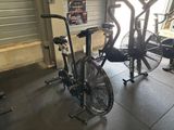a bike and a fan in a gym room