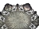 a silver plate that has a flower design on it