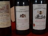 several bottles of wine are lined up on a red table