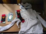 a cardboard box with a stuffed animal and a pair of socks on it