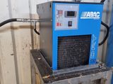 a blue machine that is sitting in the corner of a building