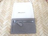 a wallet with a zipper on it sitting on the floor