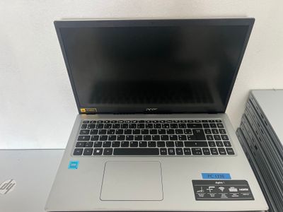 a laptop computer sitting on top of a stack of books