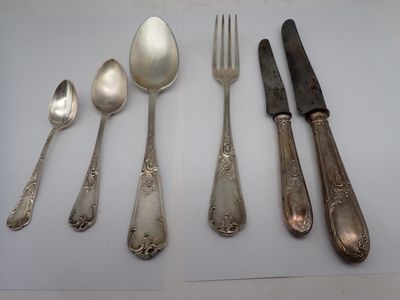 five spoons, two forks, and a knife on a table