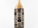 a brown vase with black and white designs on it