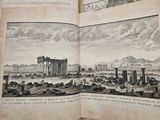 an open book with a picture of a city in the middle of it