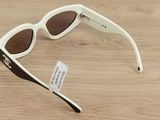 a pair of sunglasses that are on a wooden table