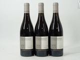 three bottles of wine sitting on top of a table next to each other
