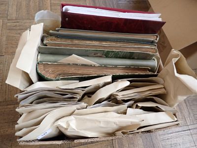 a box full of old books on the floor