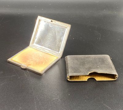 a small metal box with a mirror on top of it