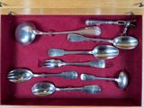 several spoons and spoon spoons in a red box on a table