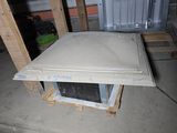 a microwave sitting on a pallet in a garage