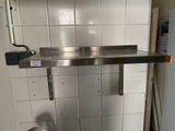 a stainless steel sink in the corner of a kitchen