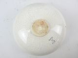 a white bowl with a cracky design on it