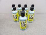 four bottles of soap sitting on top of a table next to each other