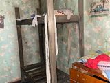 a bunk bed in the corner of a room with a wallpapered wall