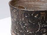 a black and white bowl on a white table
