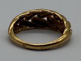 an image of a gold ring on a white surface