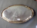 a silver tray with a mirror on it on a table