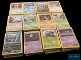 a lot of pokemon cards sitting on a table