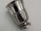 a silver cup that is sitting on a table