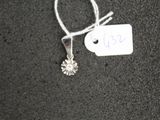 a small white tag with a silver flower on it