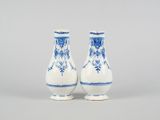 pair of blue and white vases with floral designs on them
