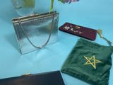 a small bag with a star on it sitting next to other bags