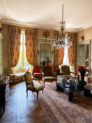 a living room with a lot of furniture and a chandelier