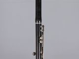 a close up of a black and silver pen on a clear surface