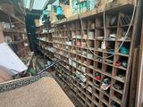 a room filled with lots of shelves and a chair