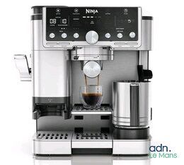a close up of a coffee machine on a white surface