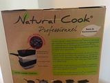 the box is open on a wooden table with a spoon and pan in it