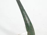 a green pipe sitting on a clear stand on a white surface