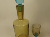 a bottle and a glass sitting on a table