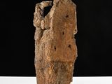 sculpture of a rock with a hole in it on a white surface