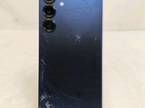 a close up of the back of a blue phone with a broken screen