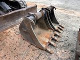a close up of a construction equipment on a dirt ground