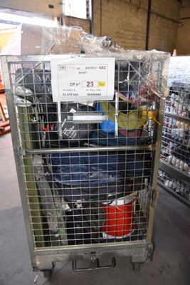 a metal cart with luggage in it in a store