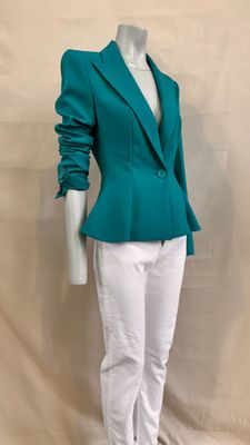 the mannequin is wearing a green jacket and white pants