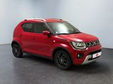 a red car is parked in a room with a white wall