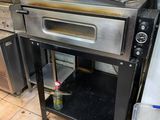 an oven sitting in the middle of a kitchen next to a stove
