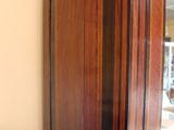 a tall wooden grandfather clock in the corner of a room