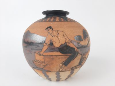 a vase with a picture of a man sitting on a bench