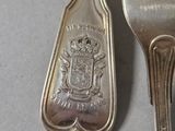 a fork and a spoon sitting next to each other on a table