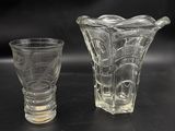 two glass vases sitting next to each other on a table